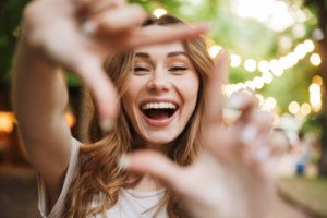 Woman outlining her smile with her fingers